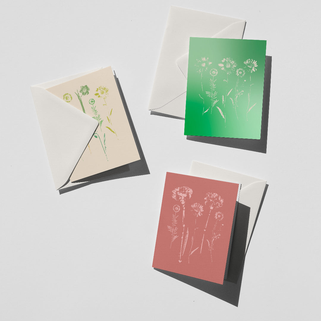 Set of greeting cards with floral designs on a light gray background