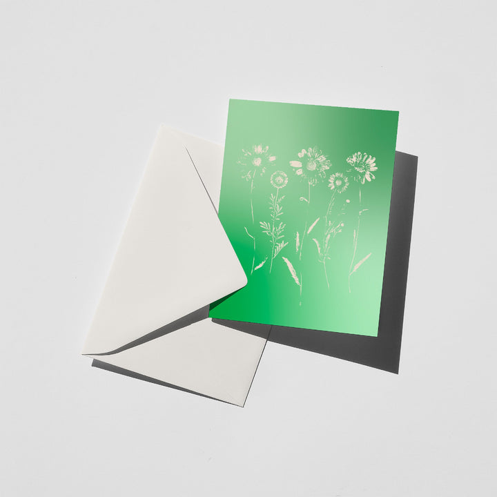 Greeting card with floral design on a green background