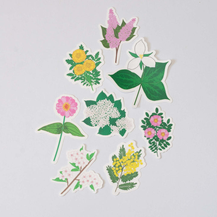 Set of colorful floral stickers on a light gray background